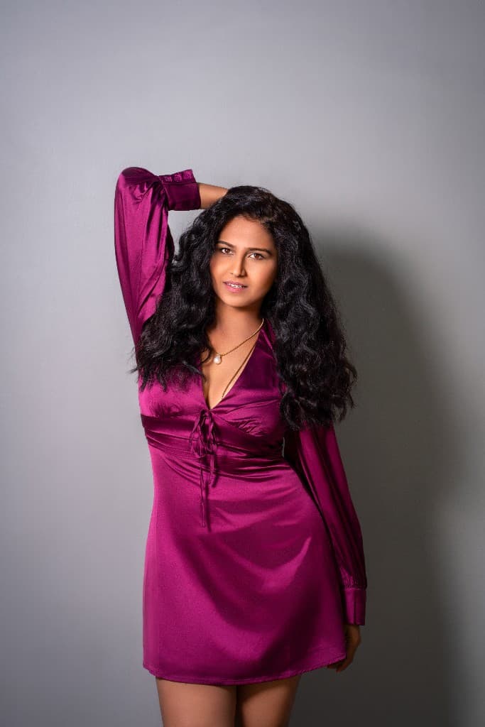 Toolieka Prakash Nikam performing in a magenta costume