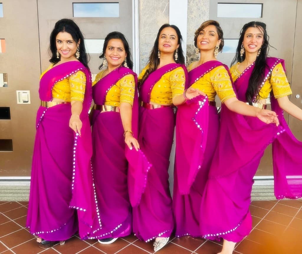 Performance group in magenta and gold sarees
